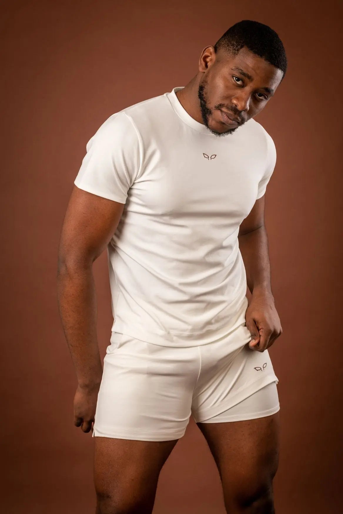 Amal t-shirt and Ergon shorts, a unisex sportswear and activewear symbiotic outfit made from sustainable and biosourced seaweed and wood fibers, with biodegradable elastane, free from toxic synthetics, eternal pollutants, and dyes, featuring the natural luminous color of the fibers in an off-white undyed shade.
