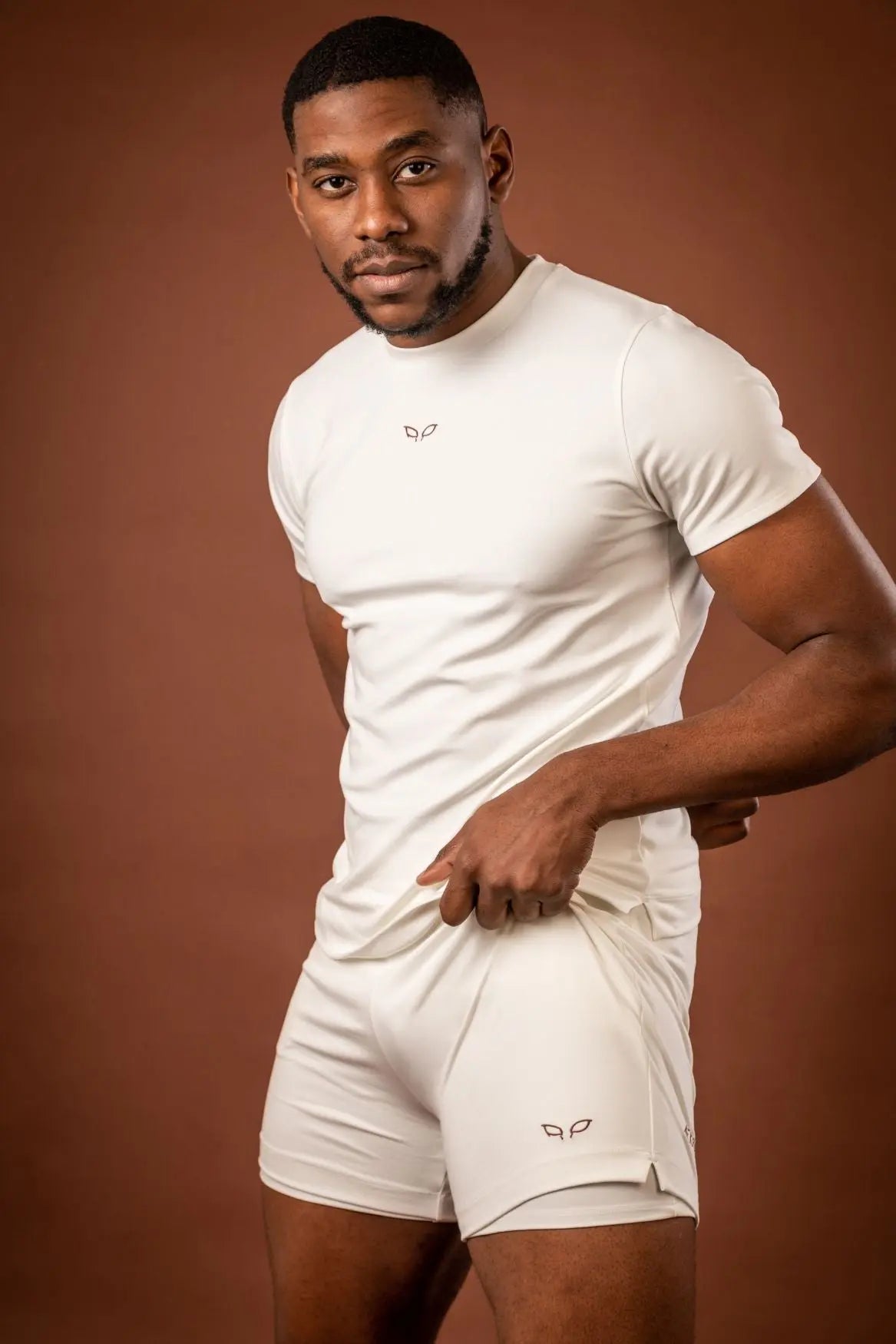 Amal t-shirt and Ergon shorts, a unisex sportswear and activewear symbiotic outfit made from sustainable and biosourced seaweed and wood fibers, with biodegradable elastane, free from toxic synthetics, eternal pollutants, and dyes, featuring the natural luminous color of the fibers in an off-white undyed shade.
