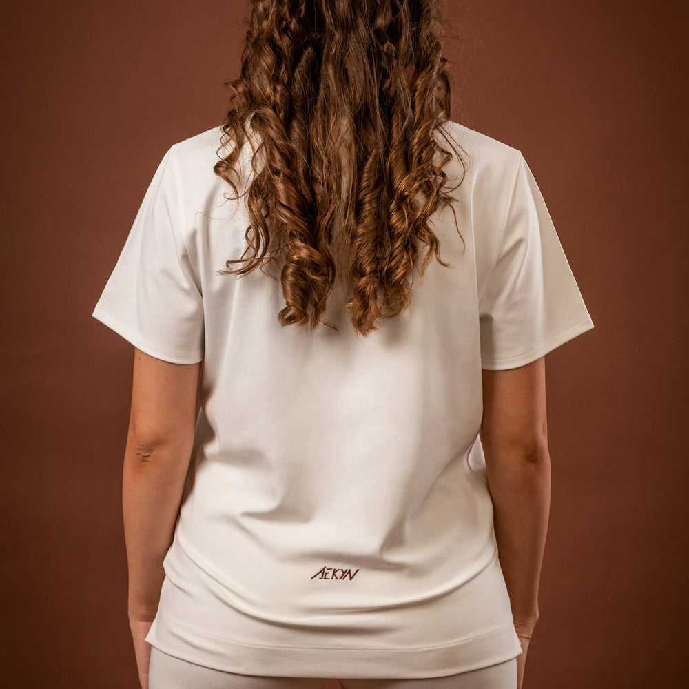 
                      
                        Amal t-shirt and Yuuki lined shorts, a versatile sportswear and activewear symbiotic outfit for women, made from sustainable and biosourced seaweed and wood fibers, with biodegradable elastane, free from toxic synthetics, eternal pollutants, and dyes, featuring the natural luminous color of the fibers in an off-white undyed shade
                      
                    