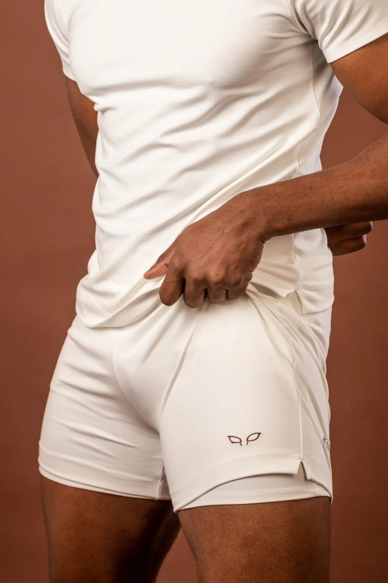 Ergon unisex sportswear and activewear shorts made from sustainable and biosourced seaweed and wood fibers, with biodegradable elastane, free from toxic synthetics, eternal pollutants, and dyes, designed for freedom of movement, showcasing the natural luminous color of the fibers in an off-white undyed shade