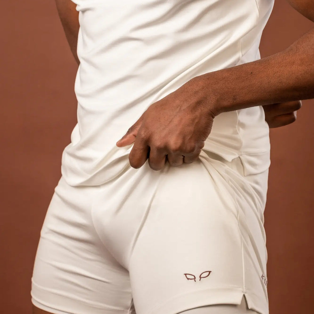 
                      
                        Ergon unisex sportswear and activewear shorts made from sustainable and biosourced seaweed and wood fibers, with biodegradable elastane, free from toxic synthetics, eternal pollutants, and dyes, designed for freedom of movement, showcasing the natural luminous color of the fibers in an off-white undyed shade
                      
                    